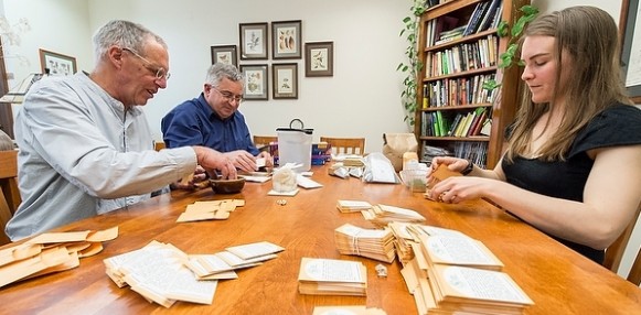 Jack Kloppenburg (left), professor in the Department of Community and Environmental Sociology, Irwin Goldman (center), chair of the Department of Horticulture, and Claire Luby (right), graduate student in the UW’s Plant Breeding and Plant Genetics program, fill envelopes with open source seeds. Photo by Bryce Richter.