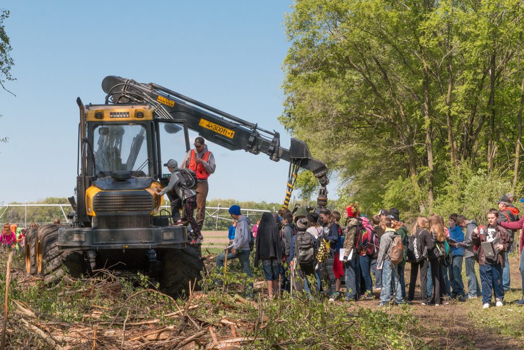 Kids waited in line for the chance to sit in a modern tree harvester at the Log-A-Load event.