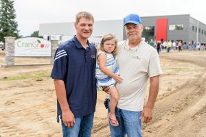 Adam Nemitz, daughter TK and father Robert represent three generations of cranberry growers near Warrens, Wisconsin. The Crangrow cooperative in Warrens, just down the road from their marshes, celebrated its grand opening Aug. 11, 2016. Photo: Bryce Richter.