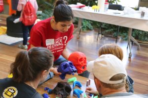 A volunteer and visitors compare 3-D-printed models of hominin skulls at the 2015 Wisconsin Science Festival’s Discovery Expo. The Discovery Expo is a hands-on, family-friendly event that takes place in the Discovery Building over all four days of the festival. Photo courtesy of Courtni Kopietz, Morgridge Institute for Research.