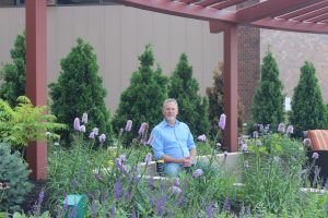 Landscape architect Sam Dennis relaxes for a moment in the just-opened Hilary Grace Healing Garden at UW Hospital, a peaceful place for patients to rest and rejuvinate.