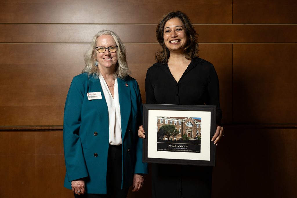 woman with award standing next to another woman