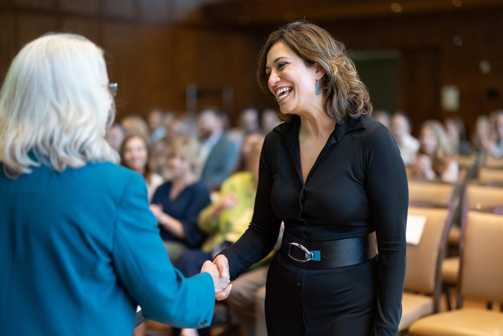 two women shaking hands