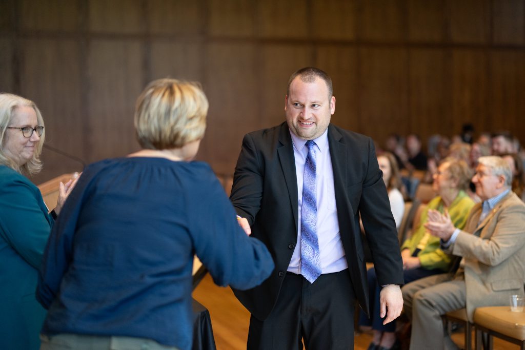 Man shaking woman's hand