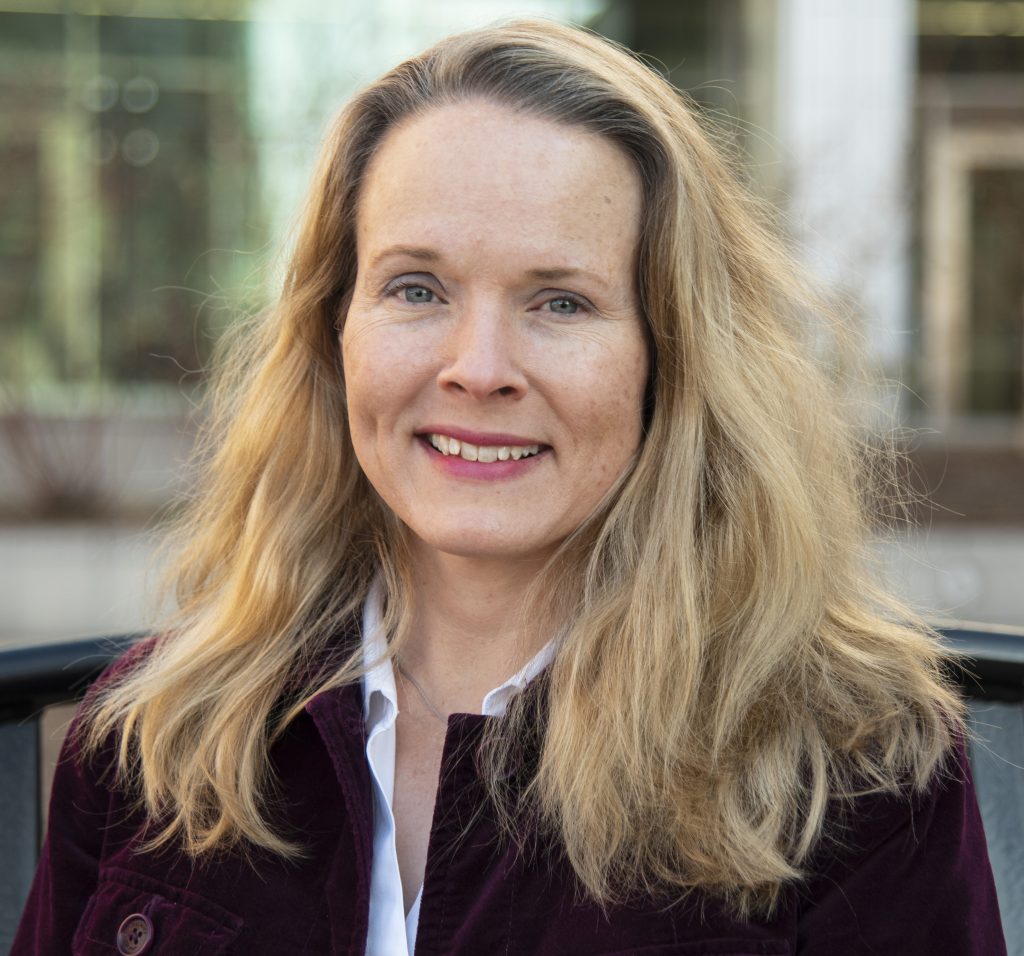 Blonde woman smiles at camera