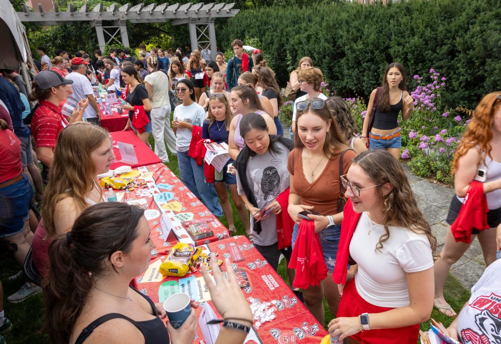 Students mingle around booths