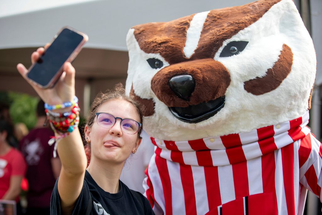 A student takes a selfie with Bucky Badger